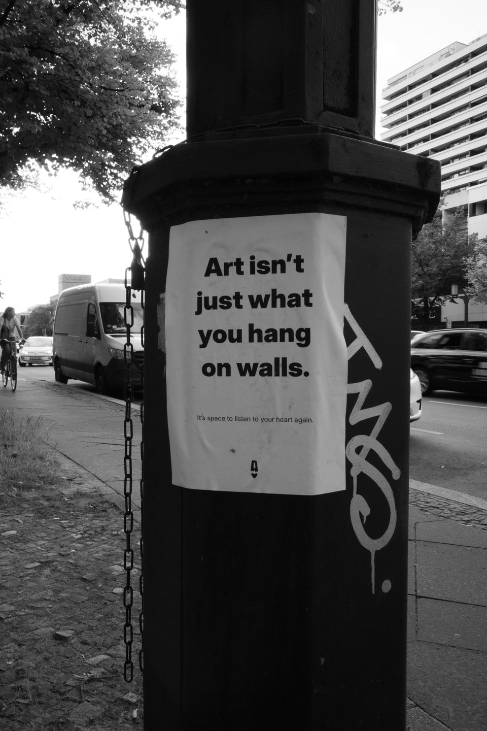 A poster reading Art isn't just what you hang on walls on a city column