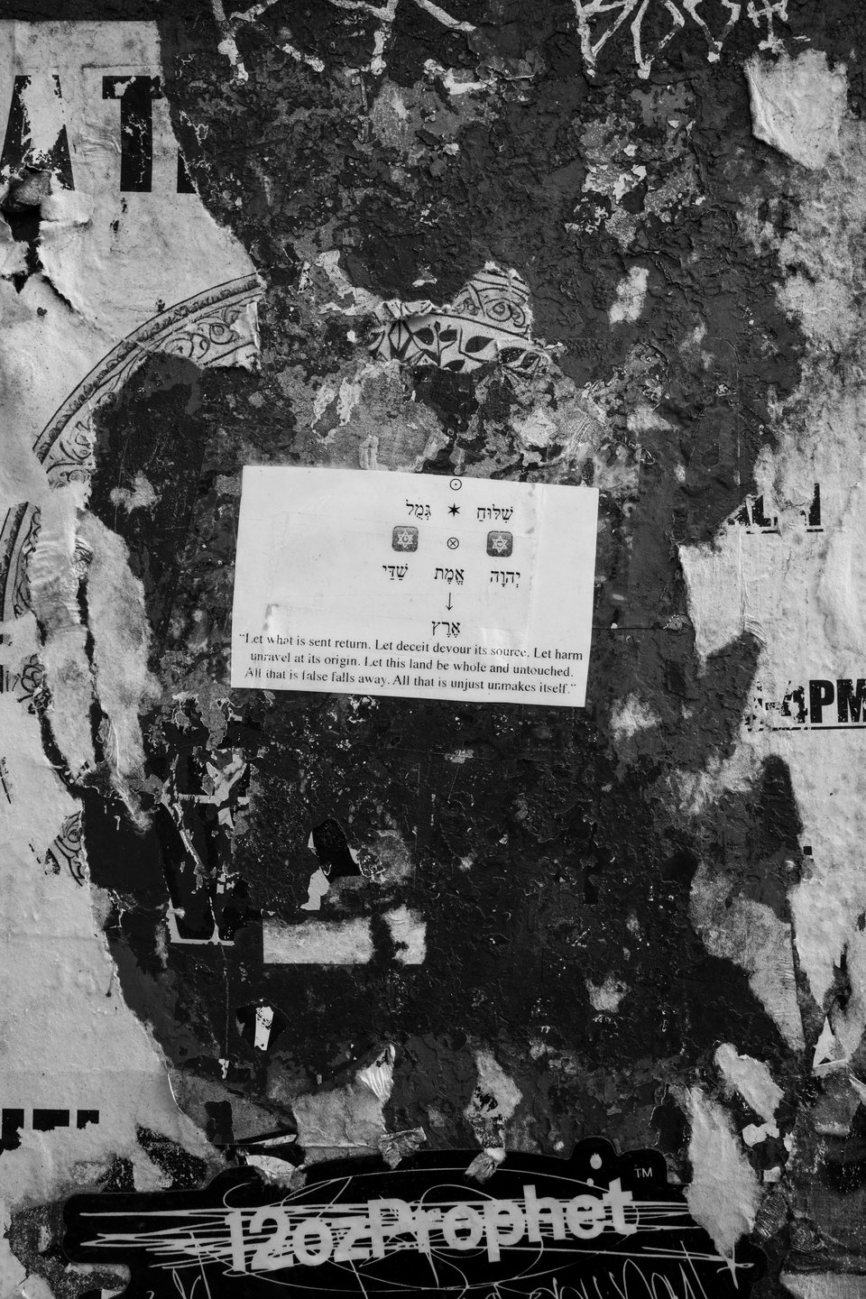 Layers of torn posters, notices, and graffiti on a wall