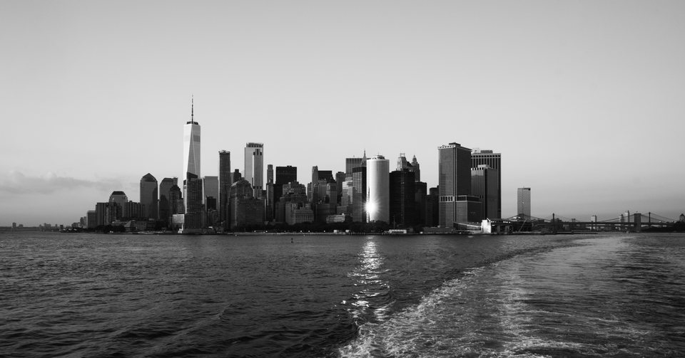 Lower Manhattan skyline beyond the wake of a boat