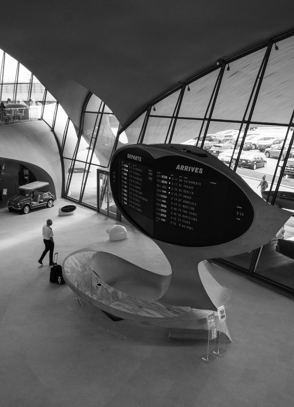 A sculptural arrivals board and a lone traveller in the TWA Flight Center