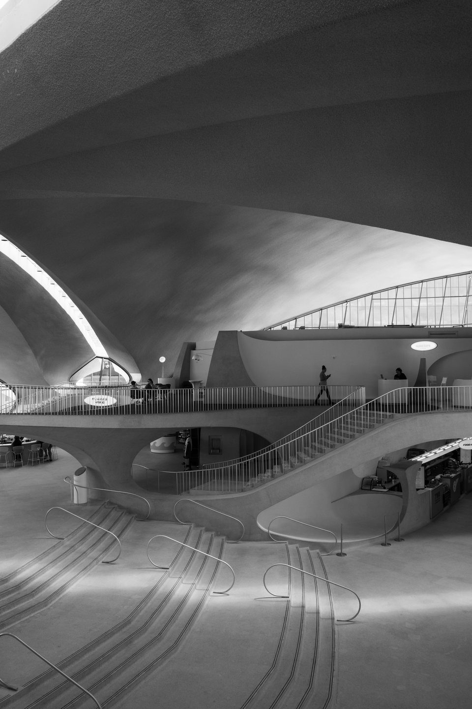 An arrivals board beneath the curved roof of the TWA Flight Center